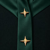 NAKHLAH close-up of branching green silk bands finished with gold star details.