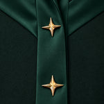 NAKHLAH close-up of branching silk bands with gold star details.