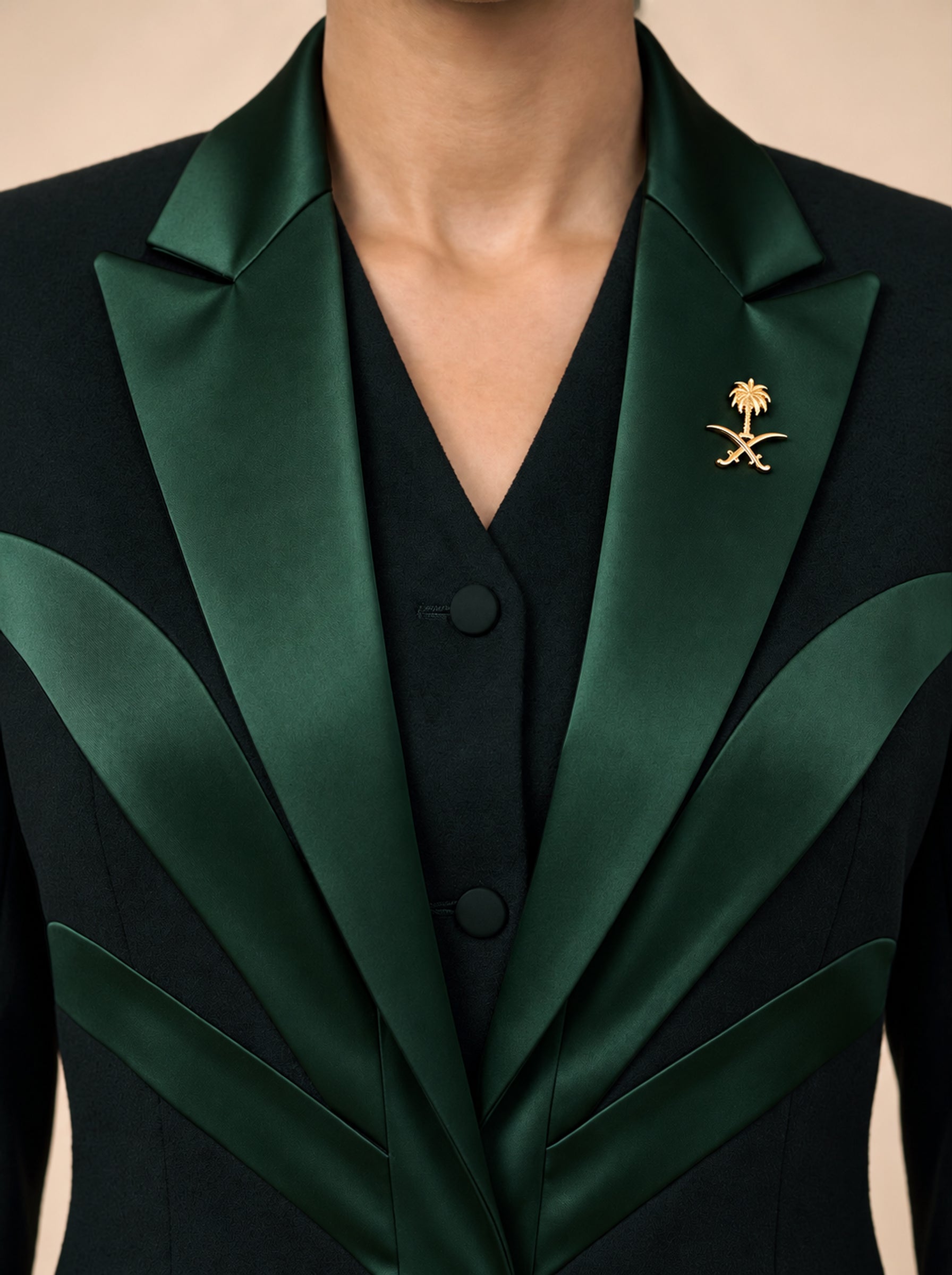 NAKHLAH upper-front detail showing branching green silk lines and the gold Saudi emblem.