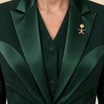 NAKHLAH upper-front detail with branching silk lines and gold Saudi emblem.