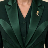 NAKHLAH upper-front detail with branching silk lines and gold Saudi emblem.