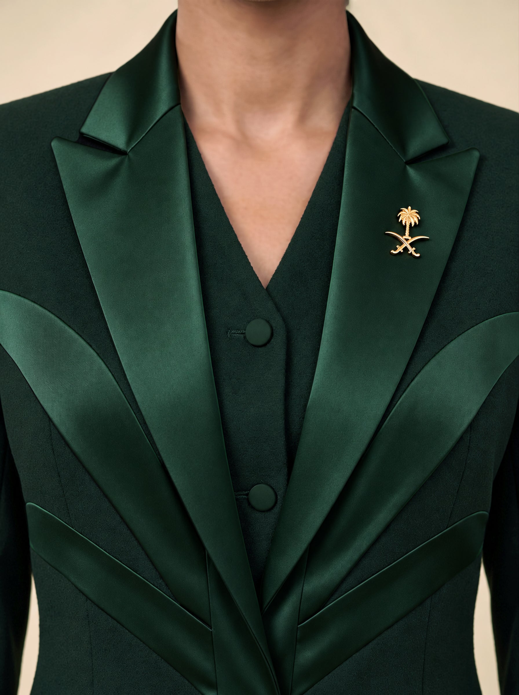 NAKHLAH upper-front detail with branching silk lines and gold Saudi emblem.