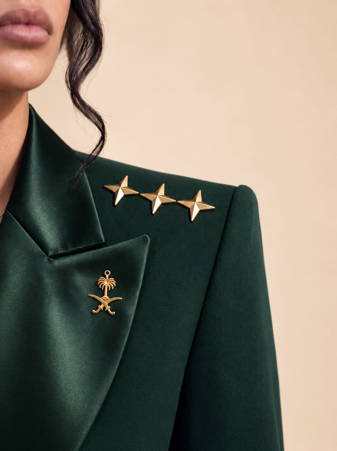 GLORY shoulder detail with gold stars and the Saudi palm-and-crossed-swords emblem on the lapel.