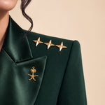 GLORY shoulder detail with gold stars and the Saudi palm-and-crossed-swords emblem on the lapel.