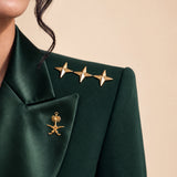 GLORY shoulder detail with gold stars and the Saudi palm-and-crossed-swords emblem on the lapel.