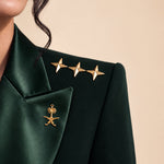 GLORY shoulder detail with gold stars and Saudi emblem.