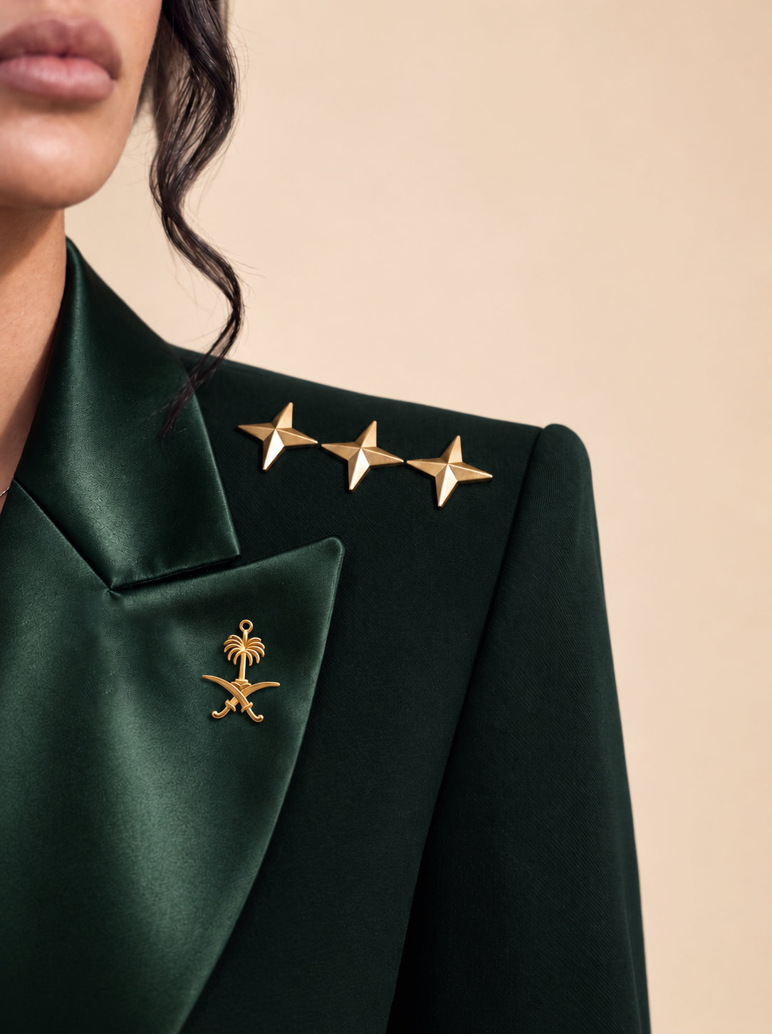 GLORY shoulder detail with gold stars and Saudi emblem.