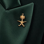 GLORY lapel close-up with the gold Saudi palm-and-crossed-swords emblem.