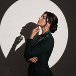 GLORY Deep Saudi Green blazer, editorial side portrait.