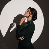 GLORY Deep Saudi Green blazer, editorial side portrait.