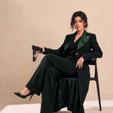 GLORY blazer in Deep Saudi Green, seated editorial full look.
