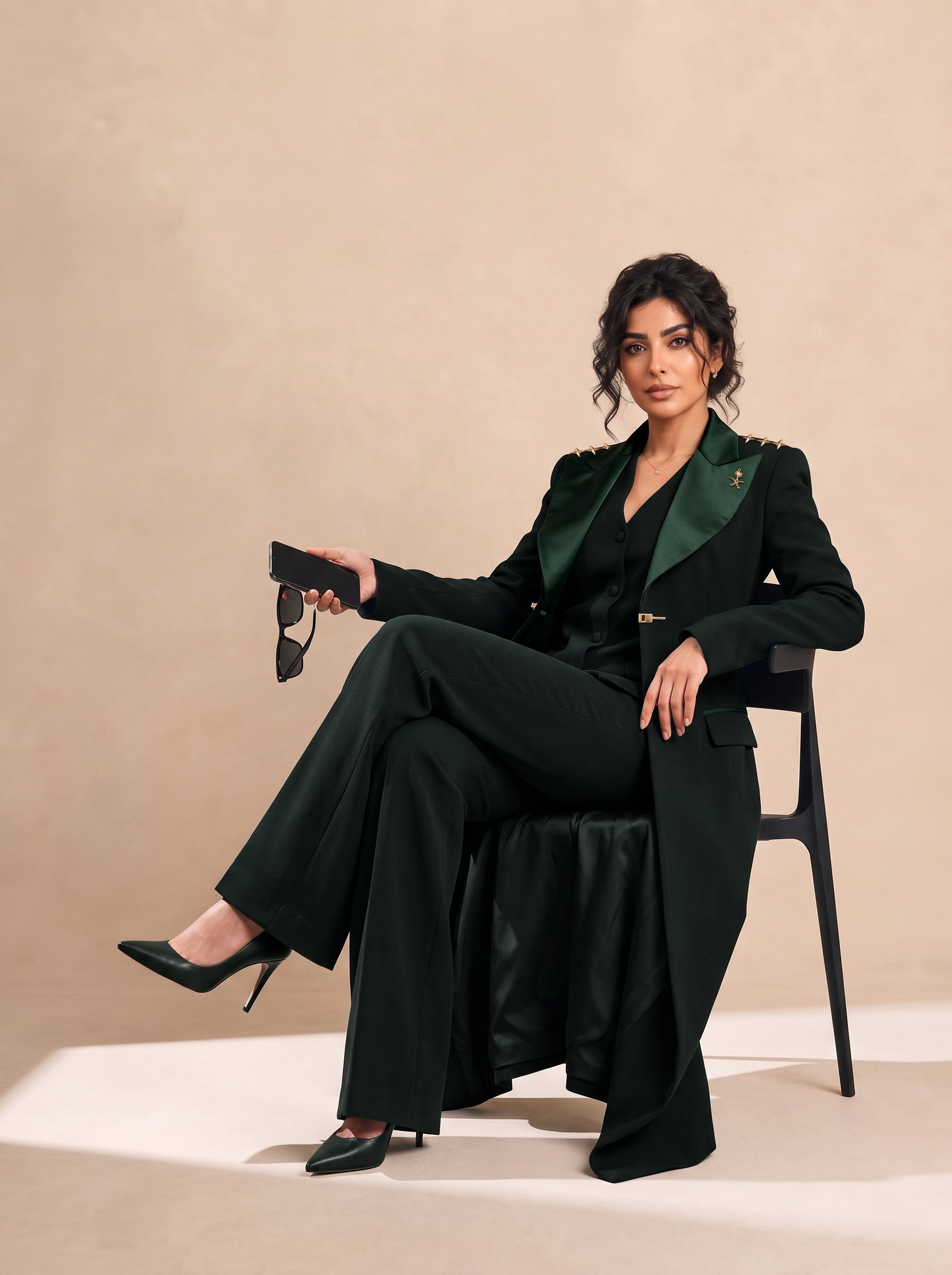 GLORY blazer in Deep Saudi Green, seated editorial full look.