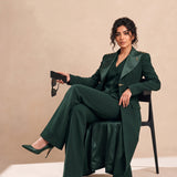 GLORY long blazer styled with a coordinating vest and trousers in a seated editorial pose.