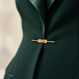 GLORY waist close-up showing the green silk lapels and gold-tone front closure.