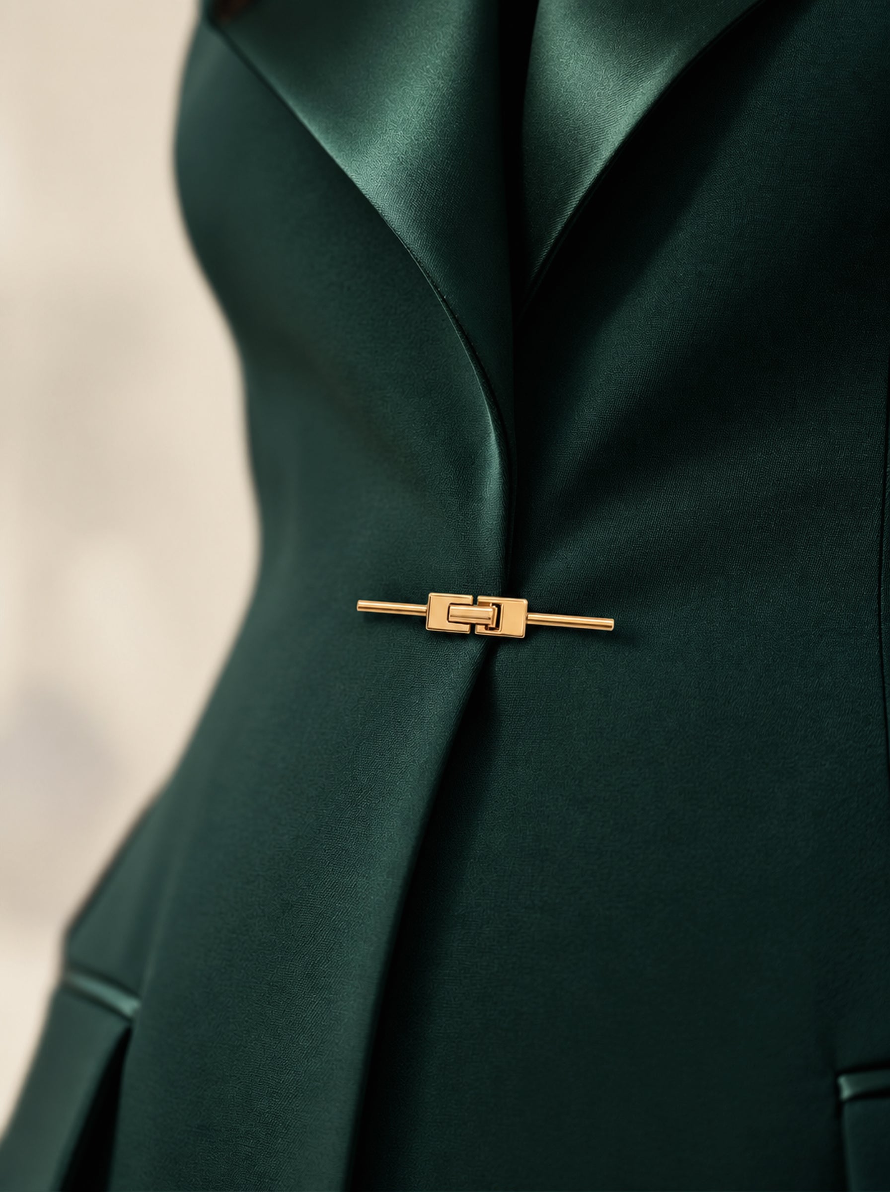 GLORY waist close-up showing the green silk lapels and gold-tone front closure.