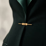 GLORY waist detail with broad lapels and gold-tone closure.