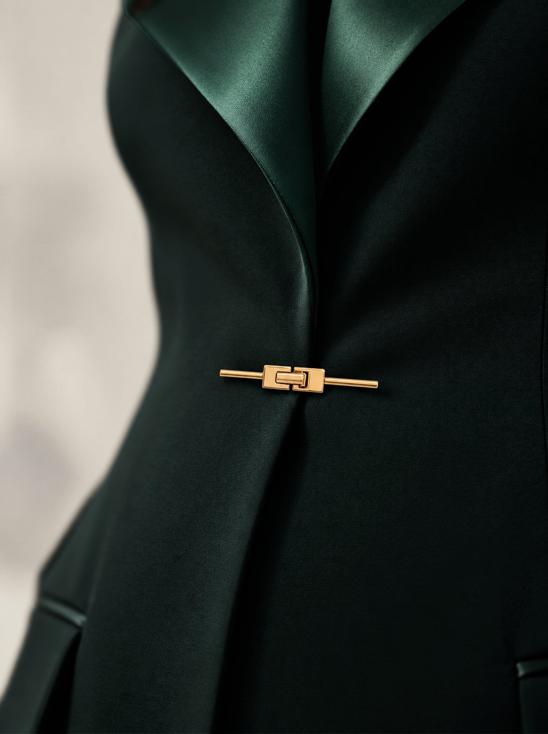 GLORY waist detail with broad lapels and gold-tone closure.