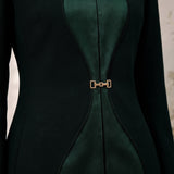 TERRA contour-inspired green silk panels and gold-tone front waist closure, close-up.