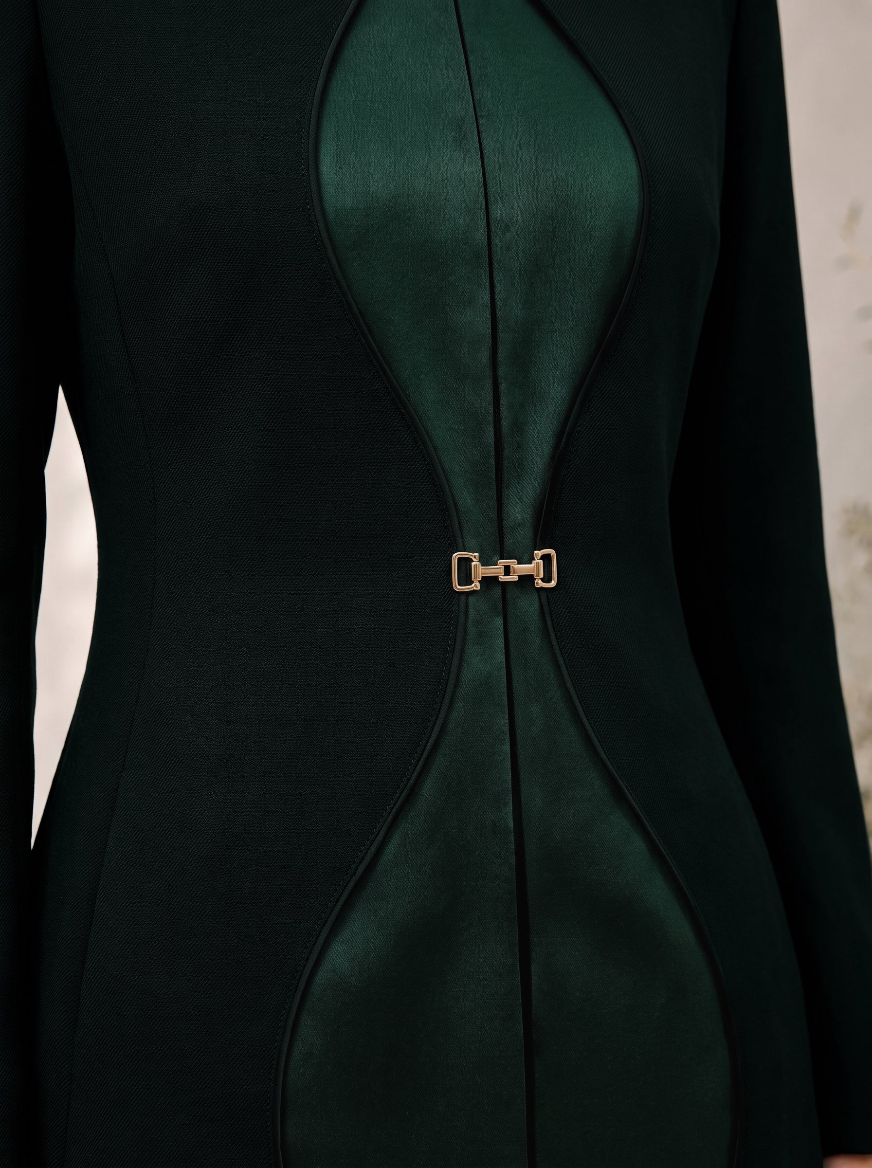 TERRA contour-inspired green silk panels and gold-tone front waist closure, close-up.